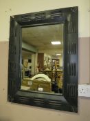 A modern industrial style metal framed wall mirror