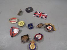 A collection of vintage enamel badges etc