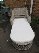 A wicker conservatory chaise longue