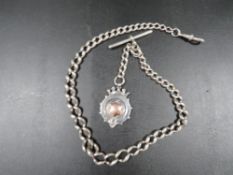 An antique silver mens pocket watch albert chain
