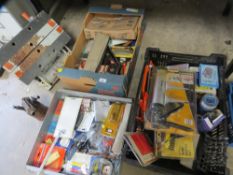 Three trays of packaged new and used tools