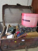 A large vintage leather suitcase with 'LAMBERT' monogram and vintage travel labels to the lid,