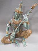 An Indonesian / Bali bronze Hindu figure of a seated female musician, approx height 34.5 cm
