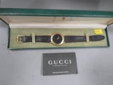 A Gucci watch in original box together with guarantee and purchase receipt from 1998
