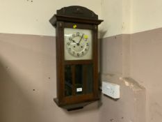An Edwardian oak wall clock