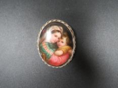 An antique painted portrait brooch