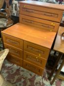 A modern chest of drawers together with a pair of bedside chests
