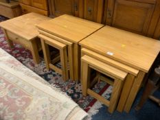 A pair of modern light oak nest of tables together with a similar single drawer table