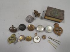 A small quantity of military badges and buttons etc