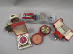 A collection of five small clocks to include Ebosa, Cyma, Tuba etc., together with two lighters