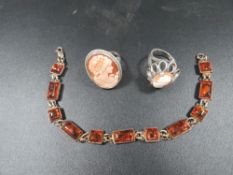 Two silver mounted cameo rings together with a hallmarked silver amber panel link bracelet