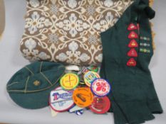 A quantity of vintage scouting memorabilia, vintage cloth and metal badges plus a vintage throw.