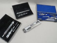 Four cased technical drawing sets