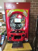 A vertical Japanese pinball machine with video display
