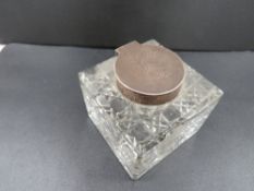 An antique silver mounted cutglass inkwell H.M. Sheffield 1907