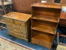 A small reproduction five drawer yew wood chest of drawers together with a waterfall bookcase