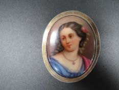 An antique painted porcelain Cameo brooch in silver frame