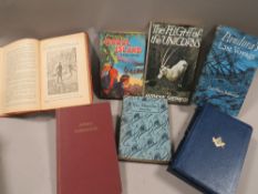 A small antique photograph album together with a small collection of books