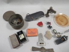 A bag of collectables to include enamel badges and a small tin of coins