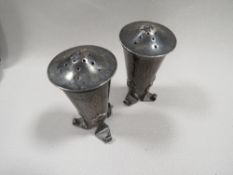A PAIR OF ARTS AND CRAFTS SILVER PEPPERS BY A.E. JONES H.M. BIRMINGHAM 1906