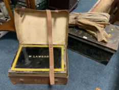 A vintage leather cased tin trunk named M Lambart together with another tin trunk, etc.