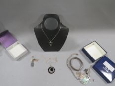 A selection of silver and costume jewellery to include black onyx pendant, silver bangle etc