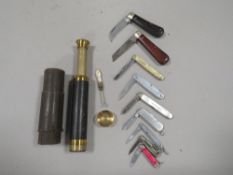 A small tray of fruit and pocket knives etc