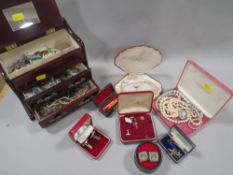 A tray of assorted costume jewellery to inc. a jewellery box and contents