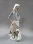 A Lladro figure of a milkmaid together with a Denby style rabbit figure (2)