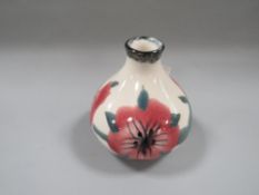 A small squat Cobridge stoneware bud vase