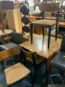 A mid-century teak drop leaf table and four chairs