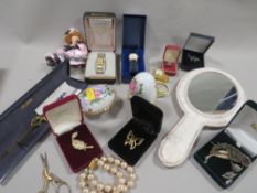 A tray of assorted costume jewellery to include watches, ceramic egg trinkets etc