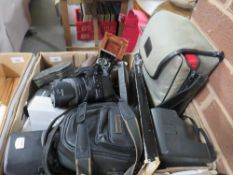A tray of assorted photographic equipment to include vintage cameras, a Polaroid, Fuji Finepix S9500