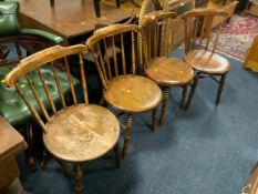 A set of four antique stick back kitchen chairs