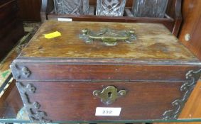 A vintage mahogany tea caddy with brass embellishments