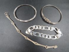 Four silver and white metal bracelets