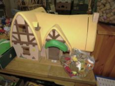 A vintage Disney Snow White and the Seven Dwarfs cottage with figures and furniture