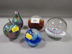 A small selection of paperweights to include two 'Isle of Wight Glass' examples - an apple and a