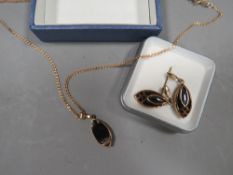 A hallmarked 9ct gold pendant set with black stone on 9ct chain, together with a pair of pierced si