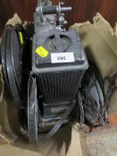 A vintage Specto film projector with manual and various reels of film