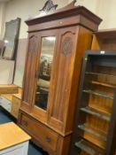 An Edwardian carved mirrored wardrobe