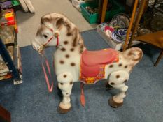 A vintage childs Mobo tin plate ride along horse