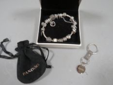 A Pandora bracelet and chains together with a Pandora keyring