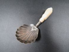 An antique silver caddy spoon
