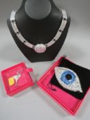 Three Butler and Wilson items to include a necklace, cocktail glass brooch and an unmarked B&W 'eye'