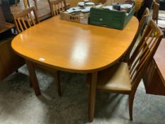 A mid-century G-Plan teak draw leaf dining table with four chairs