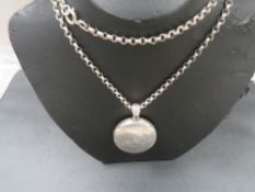 A large Victorian engraved silver locket on silver chain