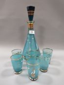 A mid century retro glass decanter with six shot glasses set having sailing ship design and gilt
