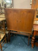 A mid-century Timeless Trend teak drinks cabinet on stand H 127 cm W 84 cm