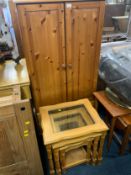 A honey pine tallboy cabinet together with a nest of tables
